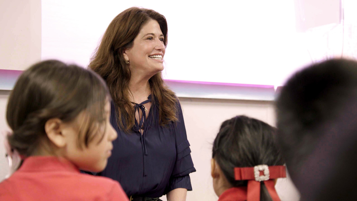 Woman speaking to children