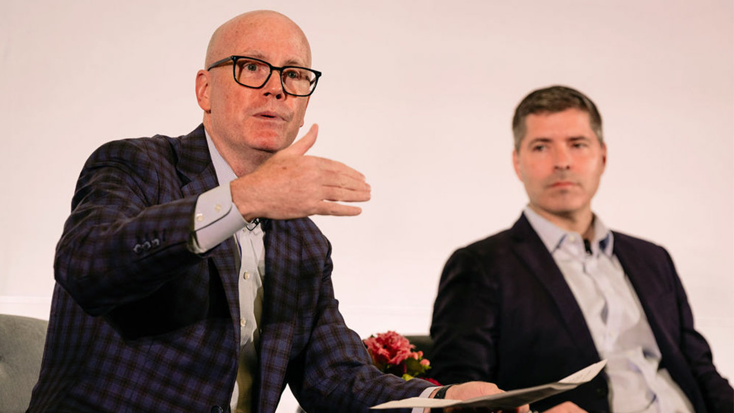 Two professionals speaking at a Financial Sponsors event