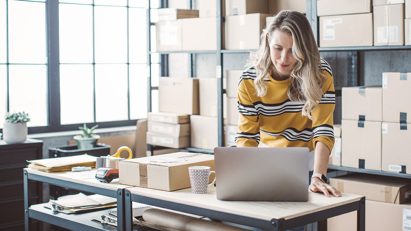woman using her laptop in an office banner