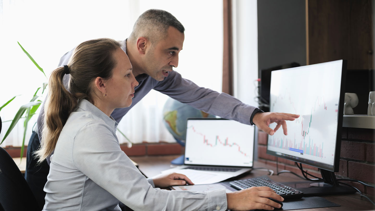 two people looking at screen banner