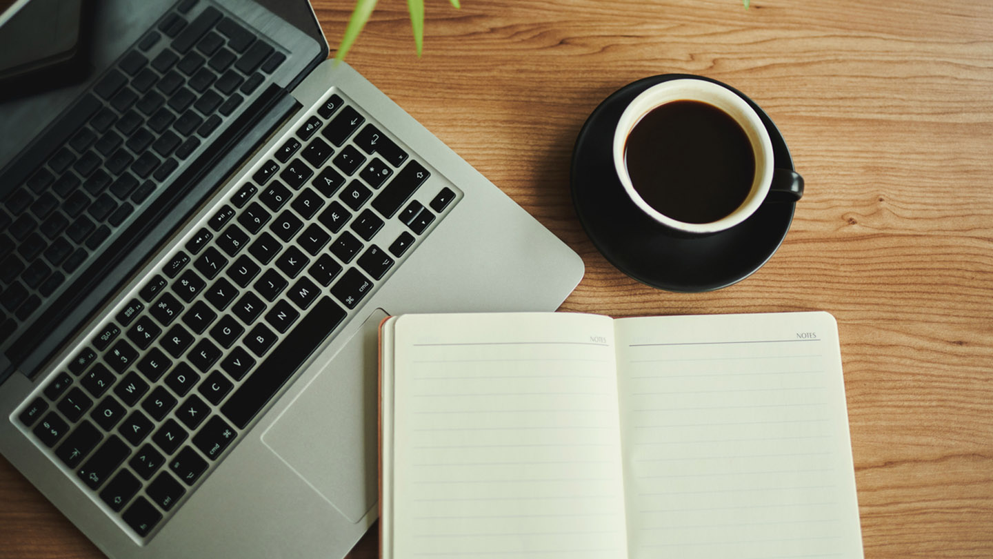 business desk with laptop computer, note book and coffee, flat lay, copy space, stock photo