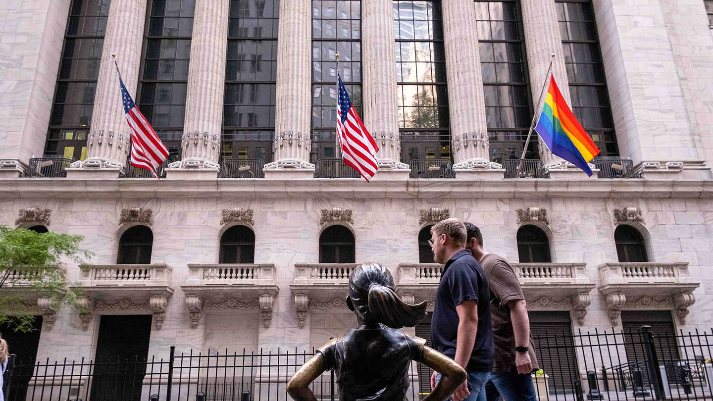 Manhattan, New York - June 4, 2022 - Tourists walking in front of Wall Street Stock exchange